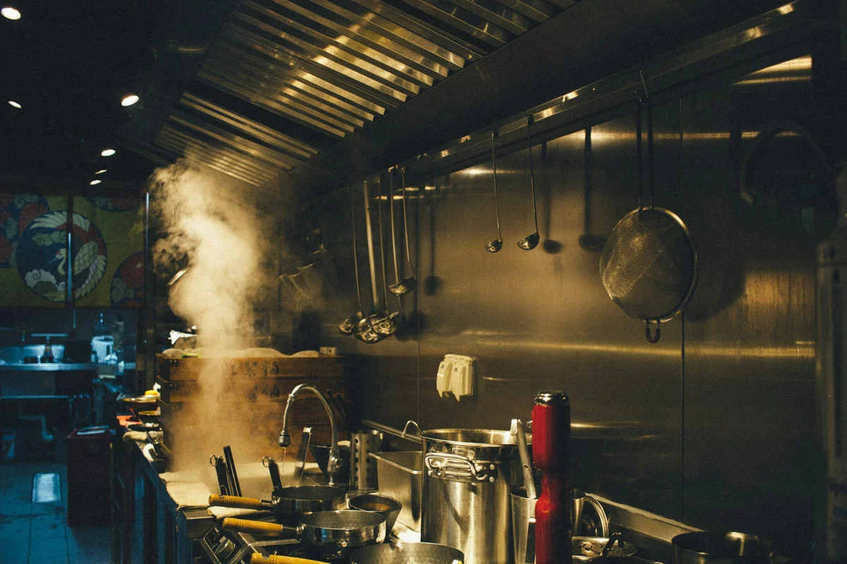 Stainless steel cooking equipment in a professional commercial kitchen
