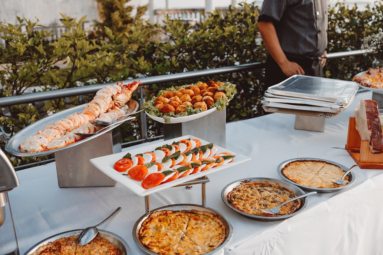 about-07 An elegant outdoor buffet set with gourmet dishes, ideal for a sophisticated dinner event.