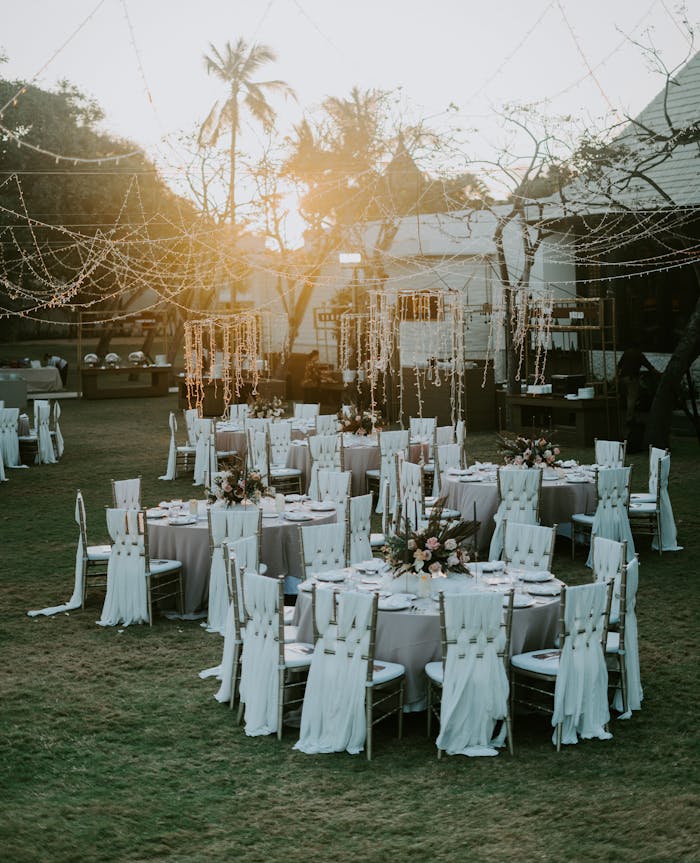 services-10 Charming sunset-lit outdoor wedding setup with adorned tables and chairs, perfect for celebrating love.
