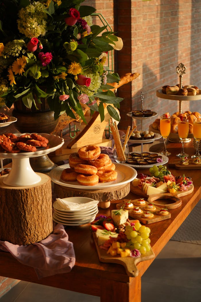 services-05 Sumptuous brunch spread featuring diverse pastries, fresh fruits, and elegant floral arrangements.