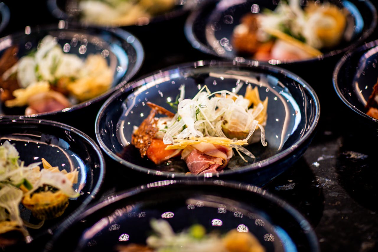 services-02 A close-up of gourmet food on elegant plates, showcasing fresh ingredients and culinary artistry.