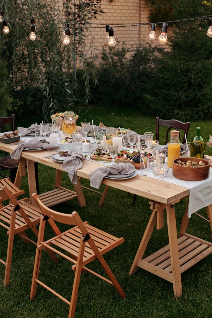 about-03 Charming outdoor dining setup with string lights and delicious meals set on a table.