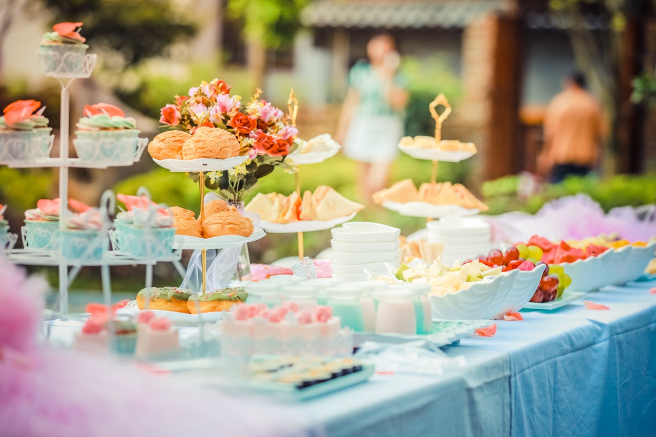 why-choose-us-02 A vibrant outdoor buffet table showcasing an array of colorful pastries and fruits, perfect for parties.